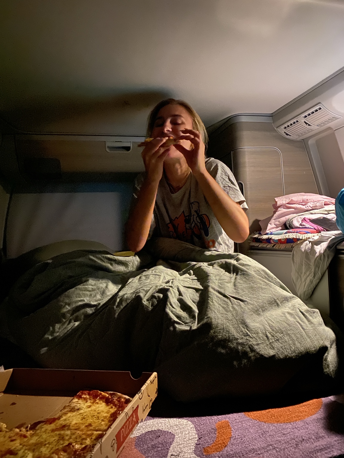 Pizza in bed inside a van
